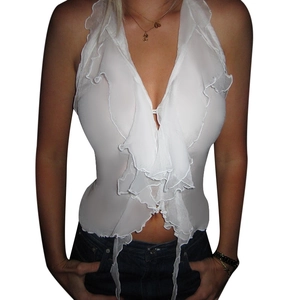 Detail view of white ruffle halter neck top made of lightweight chiffon fabric