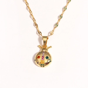 Golden titanium steel necklace featuring a colorful rhinestone ladybug pendant