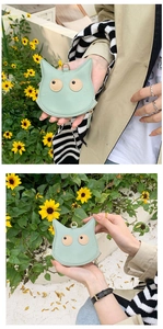 Detail of light green PU leather cat coin purse with metal ring and zipper closure