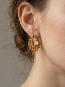 Detailed side view of vintage gold crown U-shaped earring with beaded steel ball texture