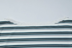 Close-up of women's striped top showing white lace trim on the neckline and knit fabric