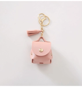 Pink PU leather mini backpack keychain with gold metal clasp and decorative tassel detail