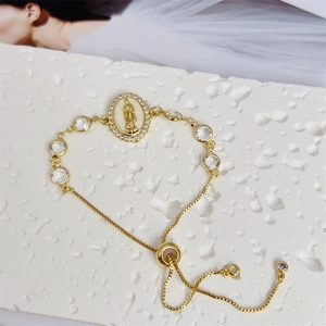 Macro shot of 18K gold plated Virgin Mary pendant with sliding adjustable clasp