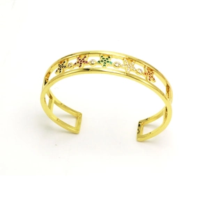 Golden double-layer open bangle with five colorful star-shaped crystals on white background