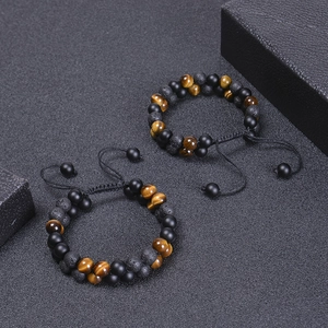 Close-up of double-layer beaded bracelets with tiger eye stone and volcanic rock details