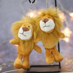 Cute lion plush keychain with golden faux fur hanging on a modern display stand