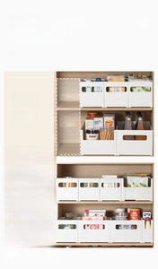 Detail showing white expandable under-sink shelf for kitchen cabinet space optimization
