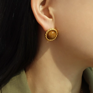 French retro tiger eye earrings with golden twisted rope texture on model ear