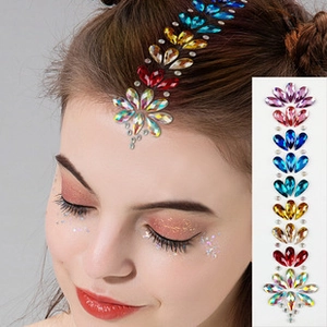 Detailed view of colorful rhinestone face jewelry stickers and model makeup application