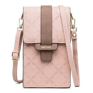 Detail of pink faux leather phone bag featuring embossed patterns and gold-tone buckle