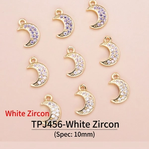Detailed view of 18K gold plated moon pendants with pavé set white and purple zircons