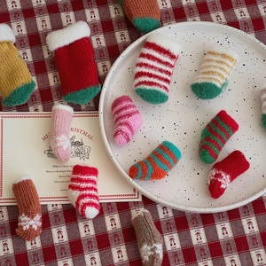 Miniature Christmas knitted socks for cutlery decoration and festive DIY crafts