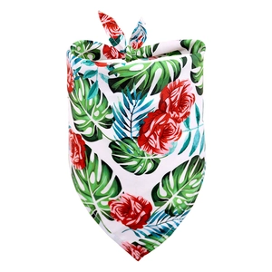 Detail of pet bandana featuring red rose and tropical green palm leaf pattern prints