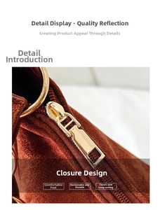 Close-up of golden zipper closure with ring pull on brown suede shoulder bag