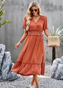 Detail view of V-neck dress with smocked waist and ruffled sleeves in terracotta color