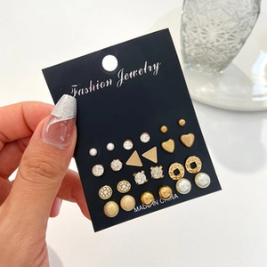 Detail of 12-pair vintage geometric earring set featuring pearls and gold studs