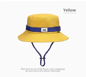 Detail of yellow sun hat featuring purple decorative ribbon and adjustable chin strap
