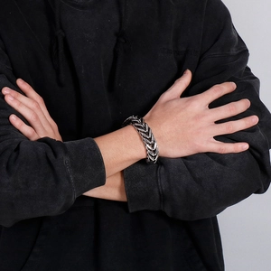 Men's punk style silver stainless steel braided V-shape chain bracelet on model wrist