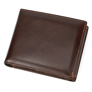 Macro shot of dark brown leather texture with yellow contrast stitching on men's wallet