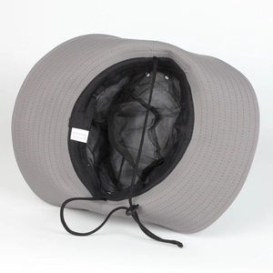 Detail of grey sun hat showing black mesh lining, adjustable chin strap, and wash label