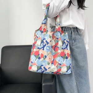 Detail of floral canvas tote bag showing artistic oil painting patterns and texture