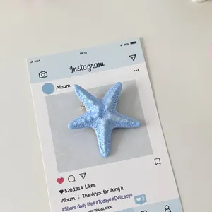 Detailed close-up of a blue starfish hair clip with realistic resin texture and metal pin