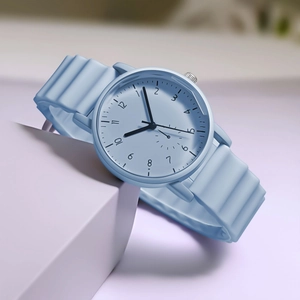 Close-up of light blue quartz watch featuring a wave-textured silicone strap and silver crown
