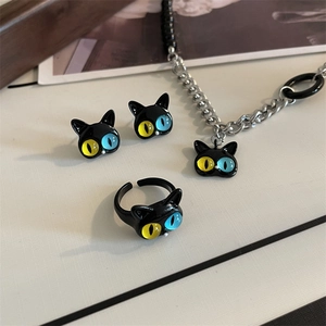 Detailed set of black cat jewelry featuring mismatched yellow and blue resin eyes