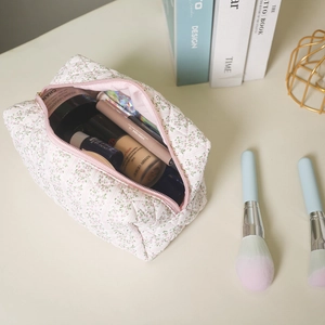 Macro detail of spacious floral quilted makeup bag showing internal storage capacity