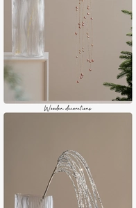 Close-up of rose gold beaded ornaments and silver glitter branch for festive home decor