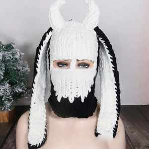 Close-up of handmade knit balaclava with black and white devil horns and long bunny ears