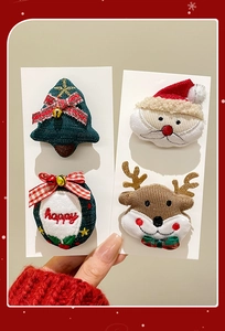 Detail of Christmas brooches featuring Santa, reindeer, tree and wreath with gold bell