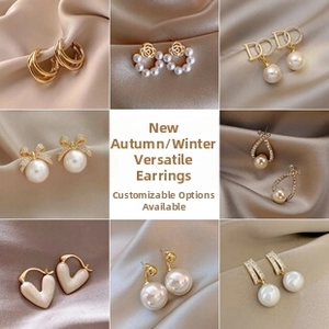 Detail view of golden nutcracker earrings with pearls and butterfly bow accents