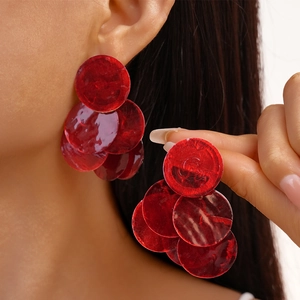 Fashionable red geometric layered circle drop earrings for women on model showcase