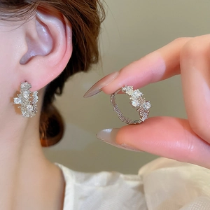 Detail shot of vintage geometric cubic zirconia hoop earrings with intricate diamond settings