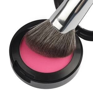 Sickle-shaped contour brush with soft synthetic bristles and vibrant rose pink blush powder