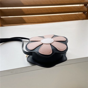 Close-up of black flower-shaped crossbody bag with pink petals and white center