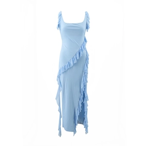 Detail of light blue dress featuring ruffles along the hem and an asymmetric side slit