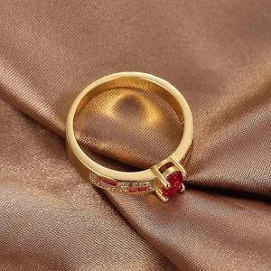 Elegant gold-plated ring with round red zircon center stone and channel-set side gems