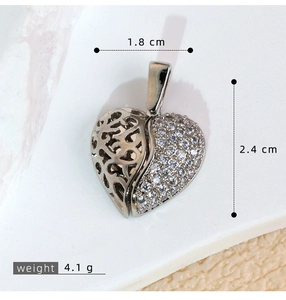Macro detail of heart wing pendant showing 2.4cm height and 1.8cm width dimensions