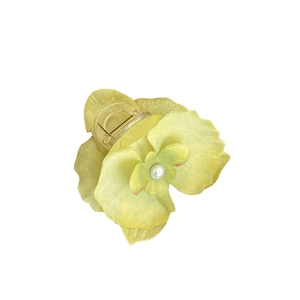 Elegant yellow orchid hair claw clip with fabric petals and center pearl detail