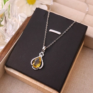 Silver necklace with a yellow pear-shaped zircon pendant and sparkling diamond halo