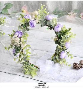 Detail of bridal floral headband with purple roses, white flowers and lace ribbons