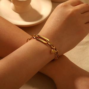 18K gold plated stainless steel Cuban chain bracelet with heart charm on female wrist