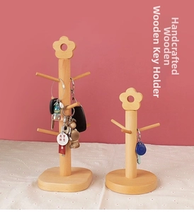 Detail of handcrafted beech wood key rack showing natural grain and floral top ornament