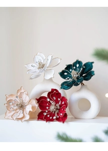 Close-up of velvet magnolia flower with gold edges and rhinestone center for Christmas decor