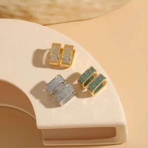 Three pairs of C-shaped cubic zirconia hoop earrings in gold, silver, and multicolor