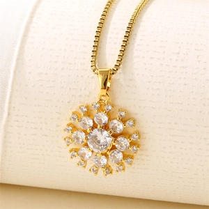 Women's gold stainless steel snowflake necklace with sparkling zircon crystals on textured paper