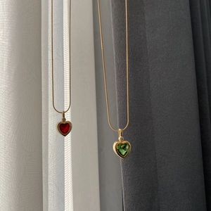 Titanium steel necklaces featuring red and green heart-shaped zircon pendants on gold chains
