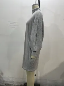 Close-up of grey high-neck knit dress showing detailed vertical ribbed texture and stitching